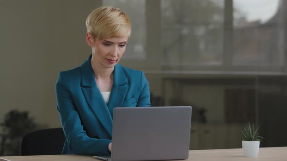 Adult 40s Business Woman Blonde with Short Hair Typing on Laptop Working in Internet Stylish Female alt