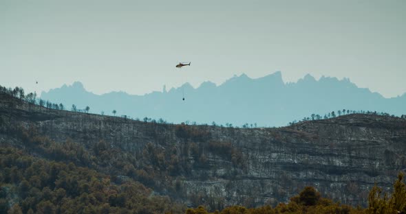 Helicopter Overflying the Wildfire Zone on Mountain in Spain Manresa alt