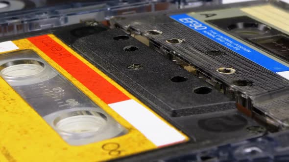 Four Audio Cassettes Rotate on White Background alt