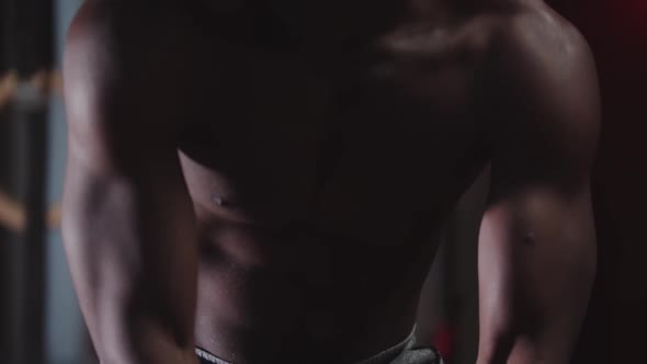 A Black Shirtless Athlete Young Man Clapping Hands Covered in Chalk alt