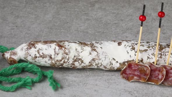 Slices of Spanish fuet Iberico sausage close up  alt