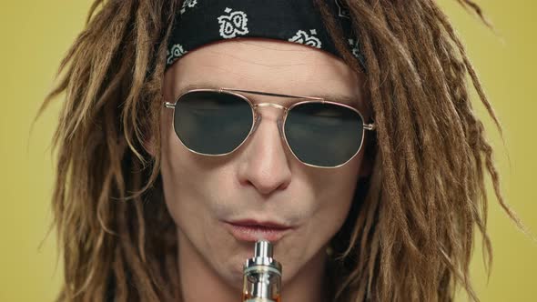 Man Smoking Electronic Cigarette. Guy Inhaling From Vaping Device alt