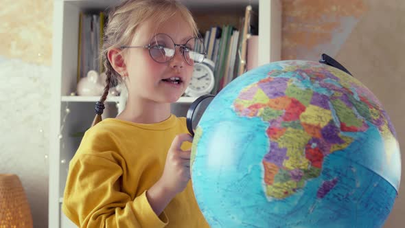 Schoolgirl is Studying the Globe