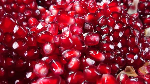Fresh Pomegranate Grain Is Falling Down on a Pile alt