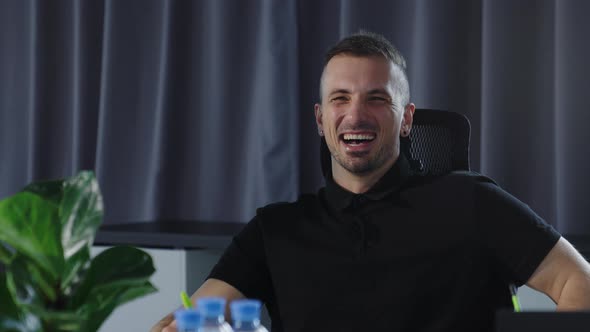Closeup of a Laughing Man During a Meeting of Colleagues in the Office alt