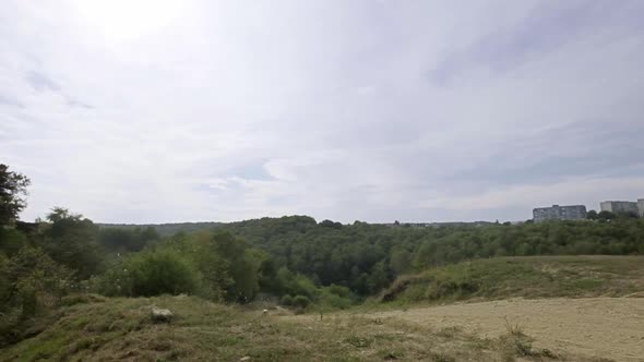 Rider On Sports Motorcycle Rides On Dirt Road He Goes Up The Hill And Makes Jump With Motorcycle alt