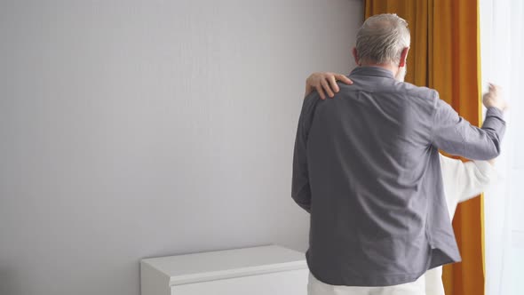 Happy Caucasian Elderly Couple Dancing At Home In Living Room alt