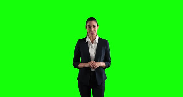 a Caucasian woman in suit talking in a green background