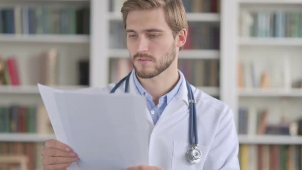 Portrait of Doctor Reading Documents in Office alt