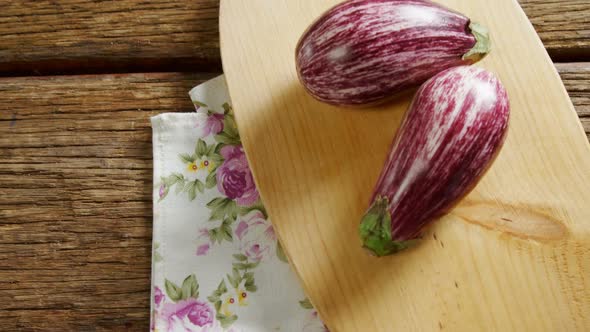 Two eggplant on chopping board 4k alt