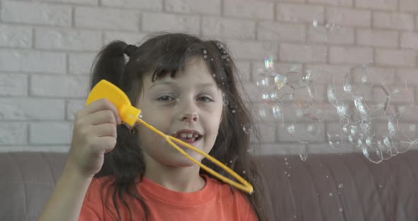 Child Blowing Soap Bubbles Indoor alt