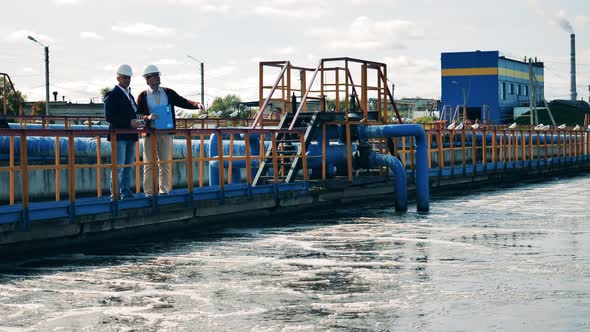 Two Inspectors Are Observing Cleaning of Wastewaters. Wastewater Treatment Concept alt