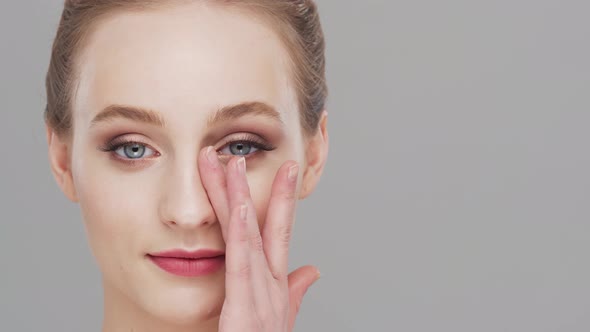 Studio portrait of young, beautiful and natural woman over grey background. alt
