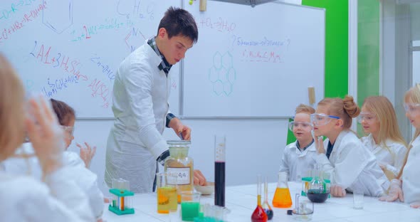 Young Boys and Girls is Making Chemistry Experiments alt