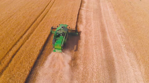  Impressive Flight Over a Working Combine Harvesting Tons of Ripe Barley alt