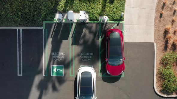  Aerial Top Down View on Electric Car Parking at the Charging Station, USA alt