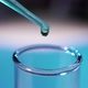 In a Laboratory, a Scientist with a Pipette Analyzes a Colored Liquid To Extract the DNA and - VideoHive Item for Sale
