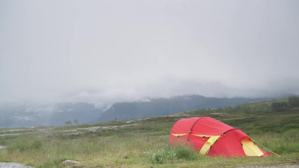 Tent In Mountains. Windy Rainy Weather, Timelapse alt