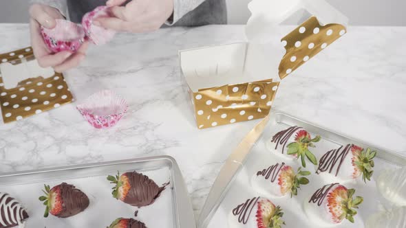 Step by step. Packaging chocolate dipped strawberries into a paper box for a gift. alt