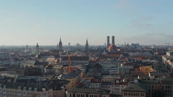 Scenic Cityscape of Munich, Germany Aerial Dolly Right with Sun Reflection of Construction Site alt