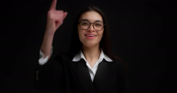 Businesswoman Points Directly at the Camera Chooses you on a Black Background