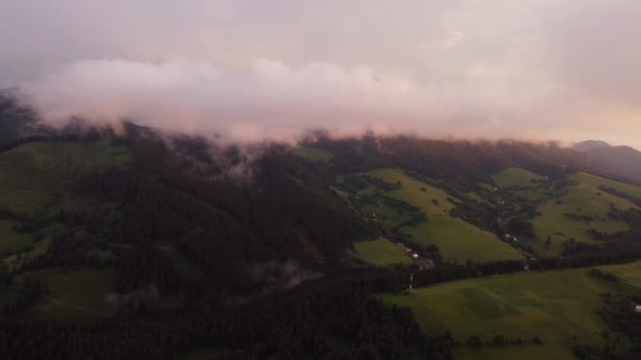 A Hilly Rural Landscape After a Burka Shrouded in Clouds at Dusk in the Golden Hour