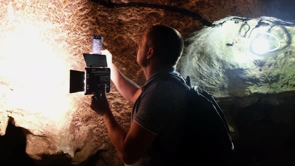 Tourist with a backpack in the cave. Speleology, cave, dungeon alt