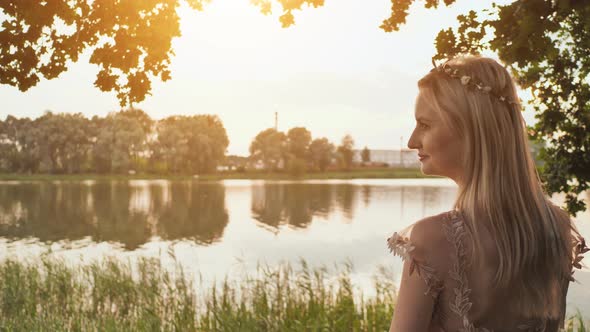 Beautiful Young Blond Woman Outdoors Portrait Near the Lake alt