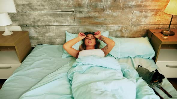 Attractive Young Woman in Pajamas Waking Up alt