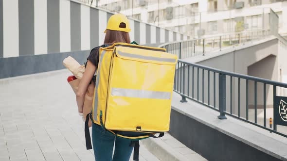 Beautiful Young Caucasian Woman in Yellow Hat and Tshirt Walking the Street on alt