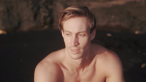 Portrait of Young Caucasian Man with Sharp Cheekbones Looking to the Camera alt