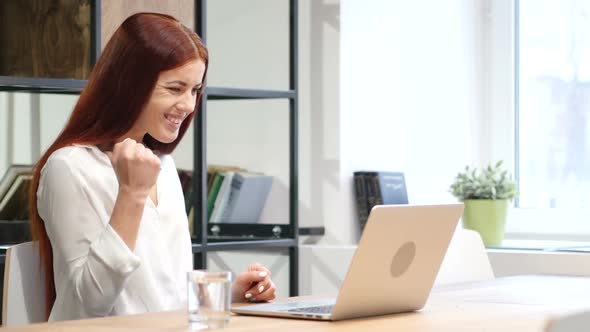 Woman CelebratingOnline Success Working on Laptop alt
