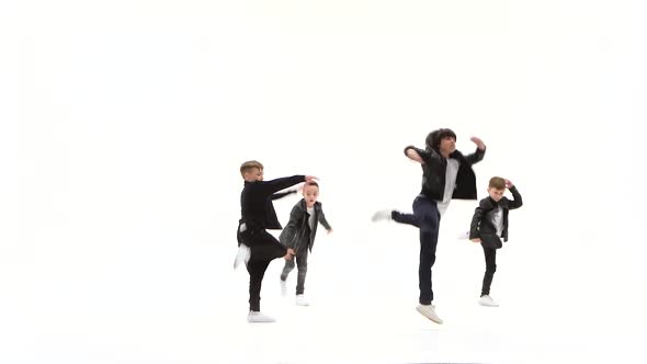 Kids Are Dancing a Modern Dance on the White Background in Black Leather Jackets and Jeans alt