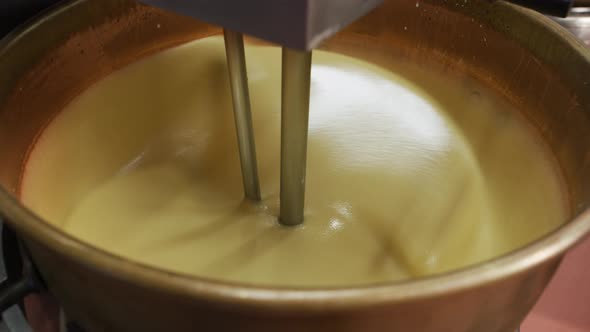 Mixing ingredients for chocolate fudge at candy factory