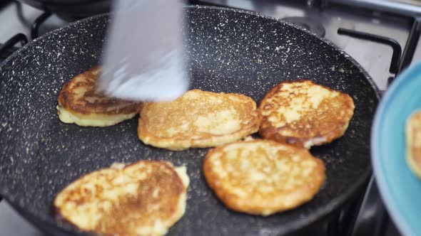 Woman Takes Draniki From the Pan alt