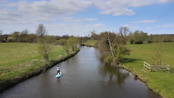 Aerial view of a woman Stand Up Paddle Boarding on Lake