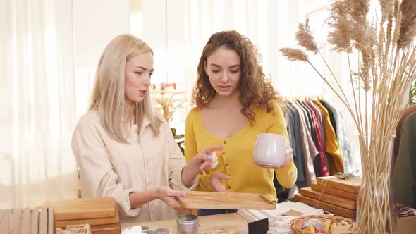 Two Women Buying Kitchen Items Mug in Shop