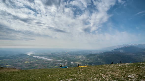 Paragliders Take Off From the Mountain in Turn