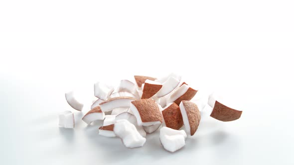 Super Slow Motion Shot of Falling and Breaking Fresh Coconut on White Background at 1000Fps alt