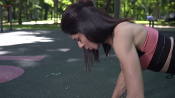 Young Active Woman Doing Fitness and Pushups on the Outdoor Sports Ground alt