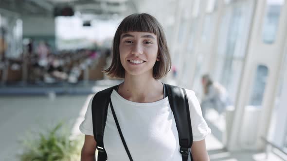 Positive Woman with Piercing in Nose Posing at Airport
