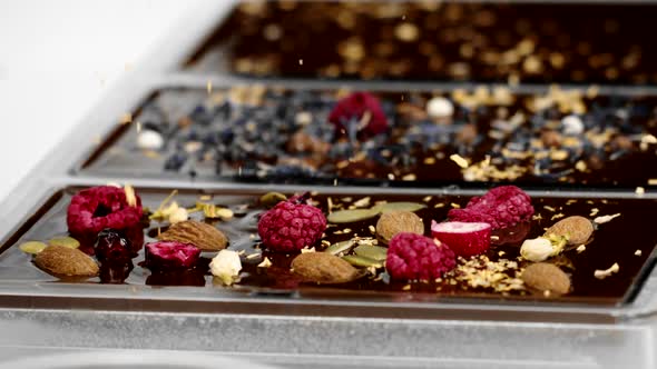 Close-up Decorating of Hand-crafted Organic Chocolate Bars with Topping, Slow Mo