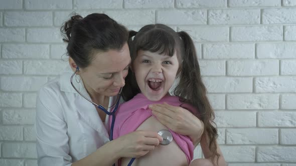Pediatrician with a child alt