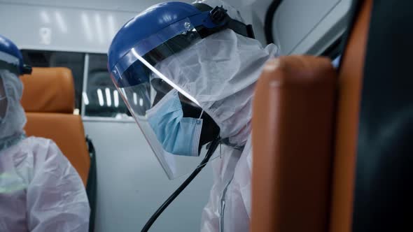 Black Paramedic Riding Ambulance with Colleague alt