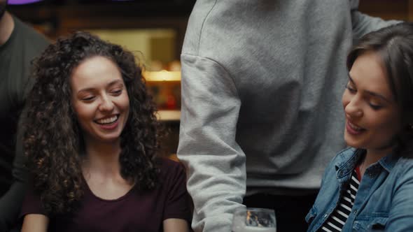 Two caucasian female friends meeting in the pub. Shot with RED helium camera in 8K. alt