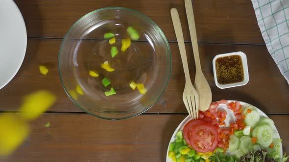 young chief woman tossing a tasty organic green salad. alt