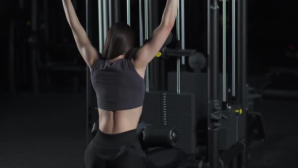 Female in the Gym Lifting Blocks on Rack Machine Strength Training on Block Device and Gym Equipment alt