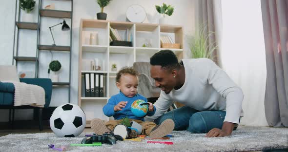 African American Dad Having Fun Together with His Cute Baby Boy at Home alt