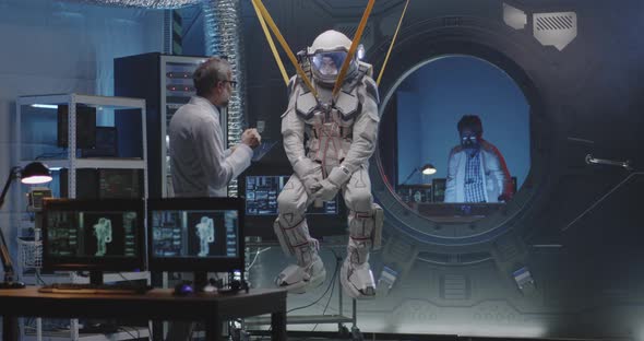 Astronaut Moving Limbs While Hanging on Bands alt