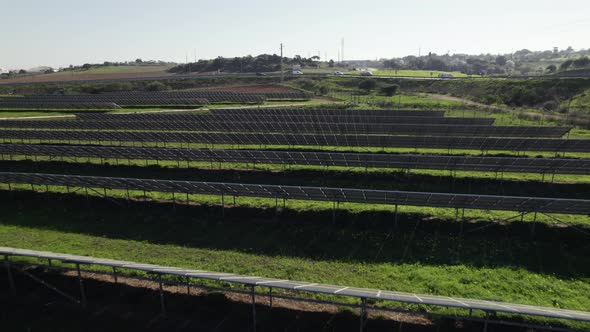 Low backwards flight over solar panels on solar farm, zero emission source